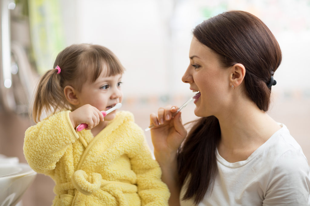 Mother and daughter brushing teeth Healthy Mouth, Healthy Body in Chester, NJ